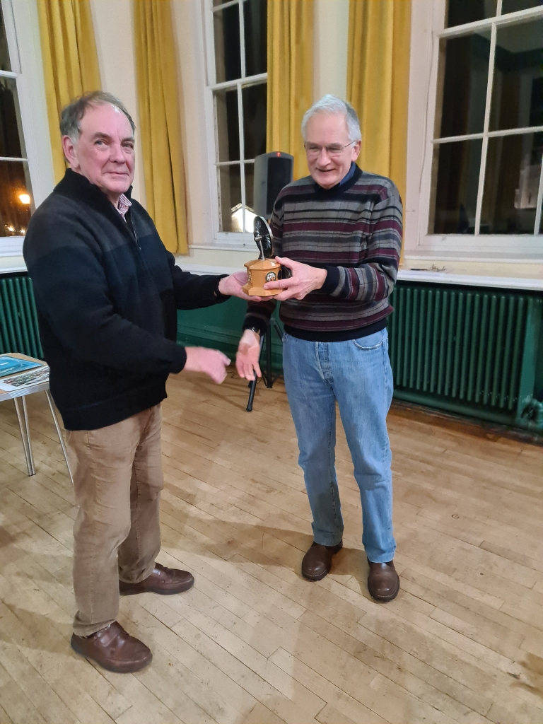 2024 winner Jim Allwood presenting the Quiz Trophy to the 2025 winner Andy Ball at the AGM and Christmas meeting